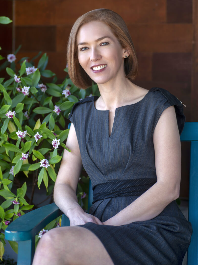 Dr. Vivian Schiedler seated on a blue chair
